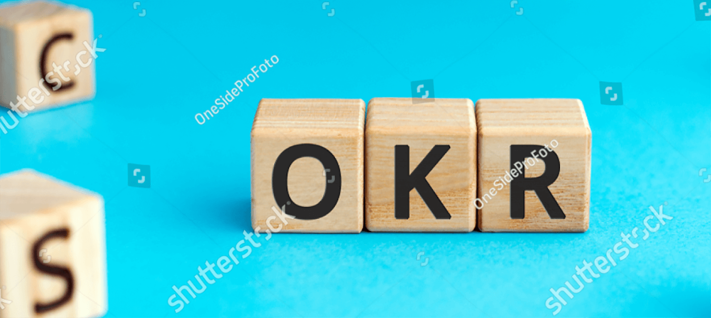 Wooden cubes with letters forming the acronyms OKR